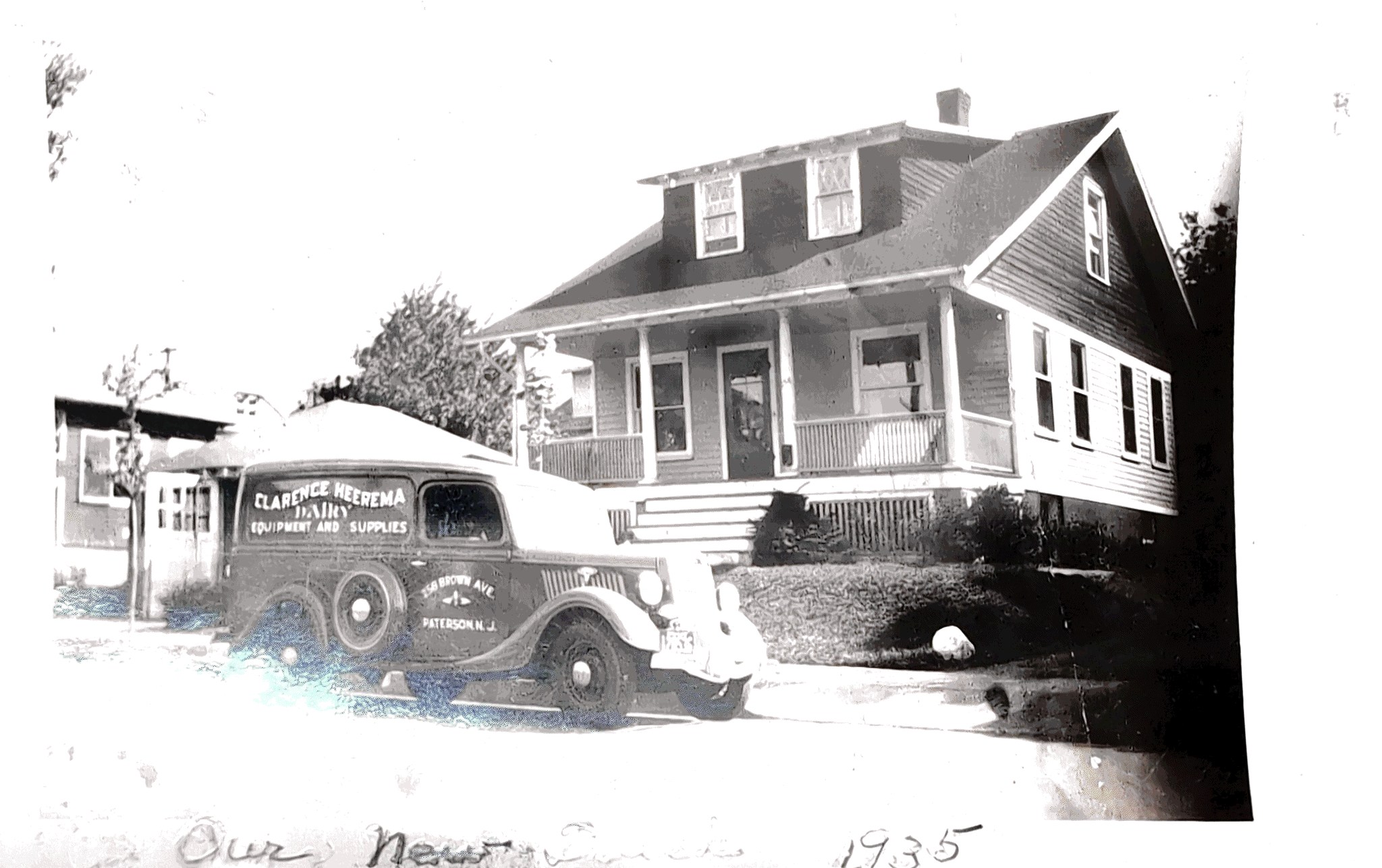 Historic 1935 Clarence Heerema Dairy Equipment and Supplies delivery truck parked in front of the original company home in Paterson, New Jersey.