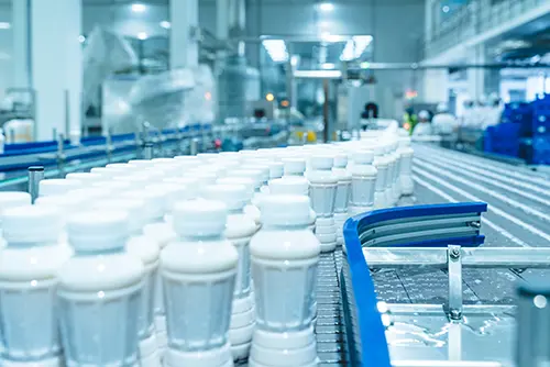 Modern food and beverage processing plant with sanitary piping systems.
