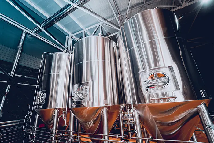 Large stainless steel processing tanks used for dairy, beverage, and food manufacturing applications.
